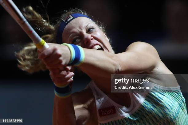 Laura Siegemund of Germany plays a backhand to Lesia Tsurenko of Ukraine during their first round match on day 2 of the Porsche Tennis Grand Prix at...