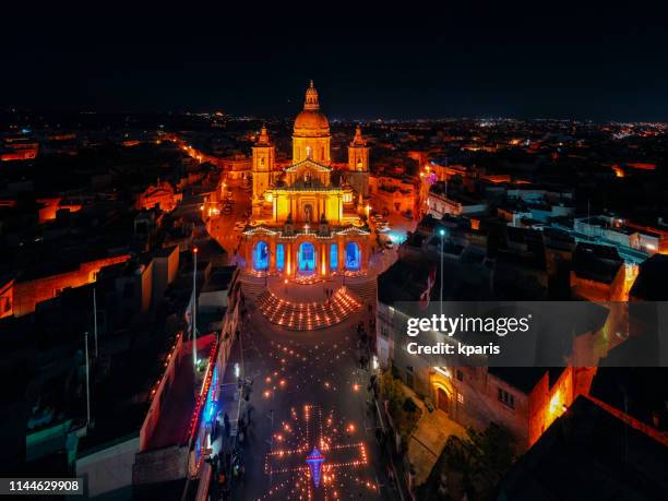 maundy thursday night time church illuminations at siggiewi, malta. drone shot - maundy thursday stock pictures, royalty-free photos & images