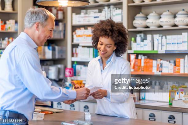let us help you fight the winter blues! - pharmacist and customer stock pictures, royalty-free photos & images