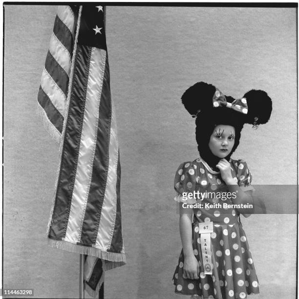 Girl dressed as Minnie Mouse competing in a child beauty contest staged at Disney World, Florida, 1999.