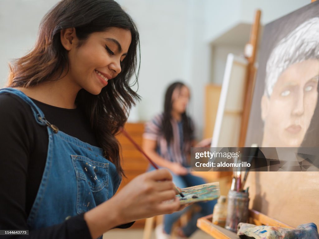Glückliche Latinierinnen bei der Arbeit an einem Gemälde