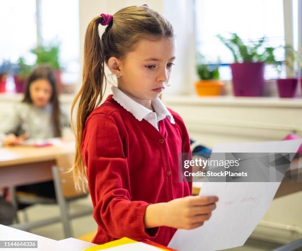 unhappy cute girl get test with bad grade - child report card stock pictures, royalty-free photos & images