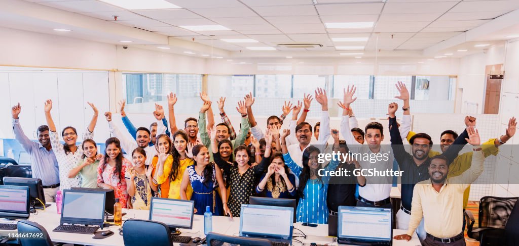 Corporate Group Portrait of Cheering Staff Members