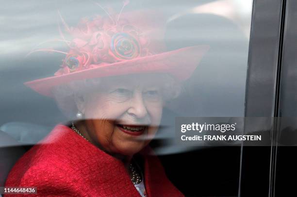 Britain's Queen Elizabeth II looks out from her car window as she leaves St George's Chapel in Windsor Castle, Windsor, west of London, on May 18...