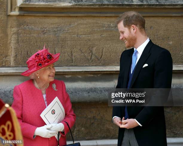 Queen Elizabeth II speaks with Prince Harry, Duke of Sussex as they leave after the wedding of Lady Gabriella Windsor to Thomas Kingston at St...