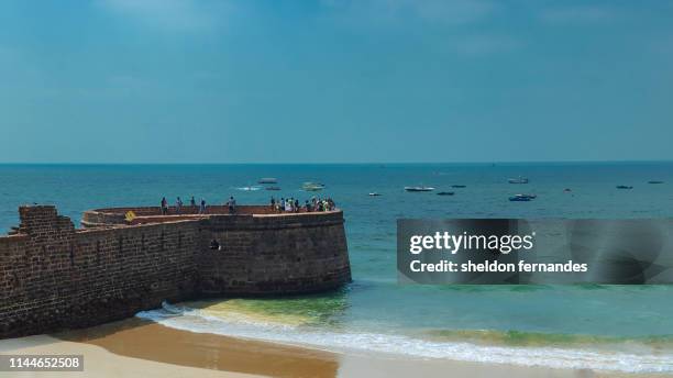 candolim beach fort aguada - goa stock pictures, royalty-free photos & images