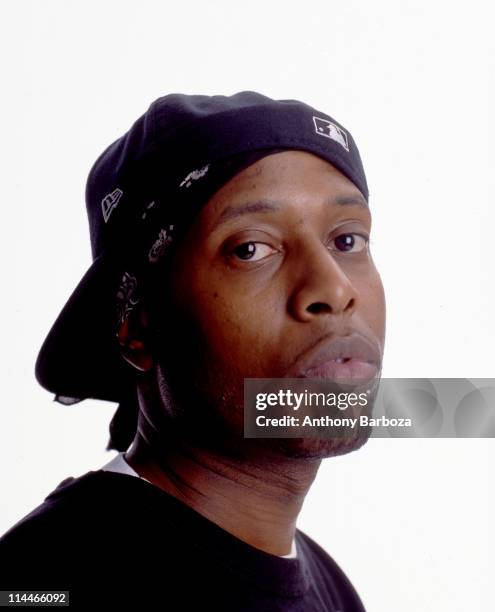 Headshot portrait of American rapper Talib Kweli, sa he poses in a baseball cap, early 2000s.