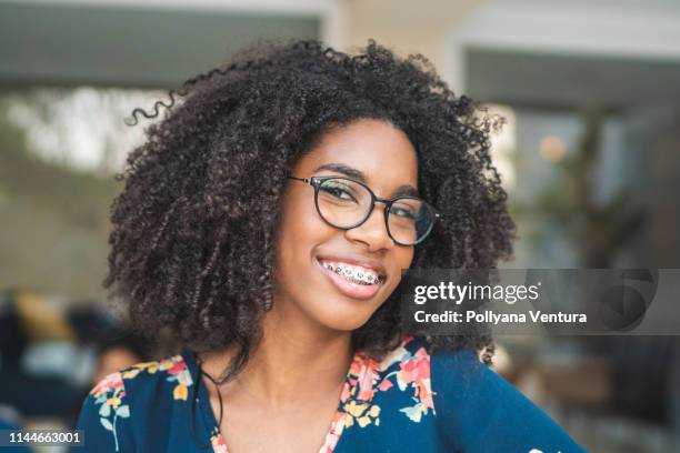 portrait of brazilian afro woman wearing glasses - braces and smiles stock pictures, royalty-free photos & images