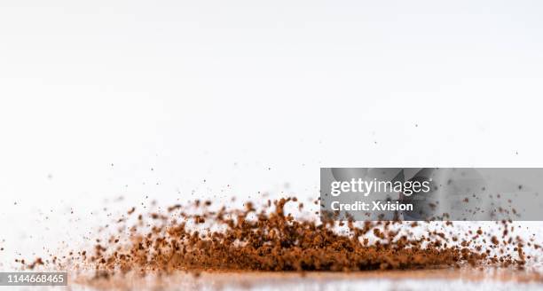 dancing coffee ground in mid air captured in high speed"n - chocolate powder stockfoto's en -beelden