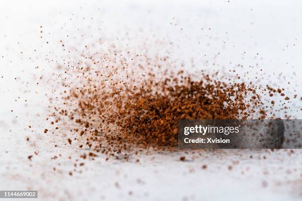 dancing coffee ground in mid air captured in high speed"n - chocolate powder stockfoto's en -beelden
