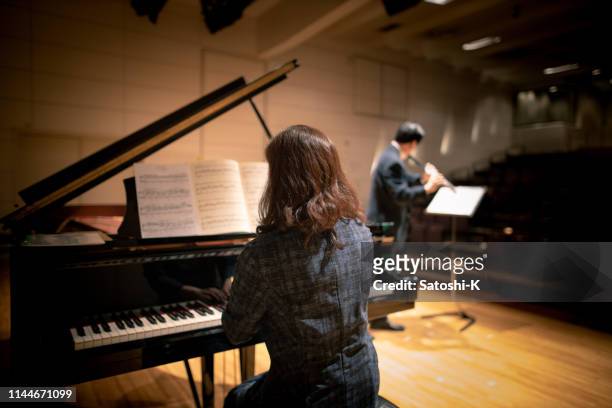 pianist and flautist playing at classical music concert - pianist stock pictures, royalty-free photos & images