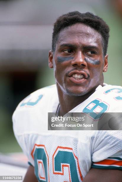 Mark Clayton of the Miami Dolphins looks on from the bench during an NFL football game circa 1990 at Joe Robbie Stadium in Miami, Florida. Clayton...