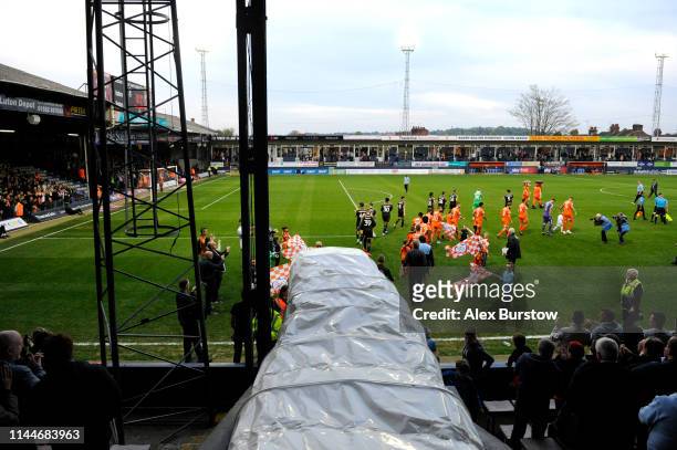 Match officials, players and mascots walk out prior to the Sky Bet League One match between Luton Town and AFC Wimbledon at Kenilworth Road on April...
