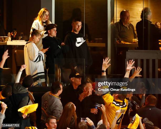 Justin Bieber and wife Hailey Rhode Bieber look on as fans Boston Bruins fans celebrate during the third period of Game Seven of the Eastern...