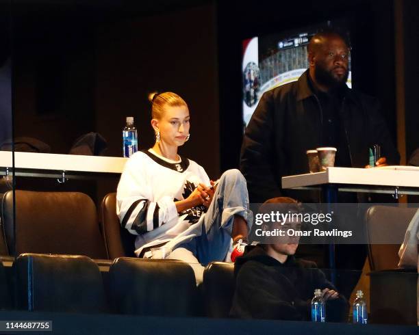 Justin Bieber and wife Hailey Rhode Bieber look on during the third period of Game Seven of the Eastern Conference First Round during the 2019 NHL...