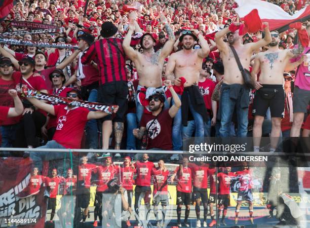 Bayer Leverkusen players are reflected in a glass railing as they celebrate with their fans afte rthe German first division Bundesliga football match...