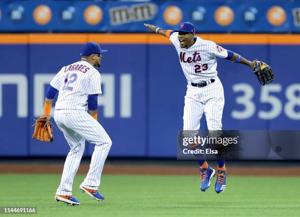 Keon Broxton and Juan Lagares of the New York Mets celebrate the win over the Philadelphia Phillies at Citi Field on April 23, 2019 in the Flushing...