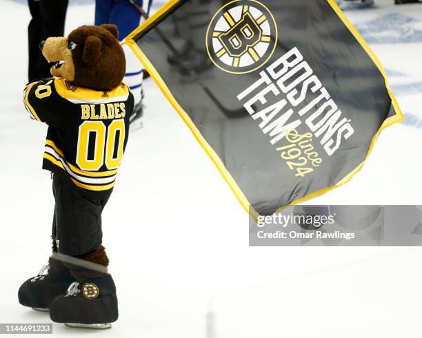 The Boston Bruins mascot "Blades the Bear" waves the team flag after the victory over the against the Toronto Maple Leafs during Game Seven of the...