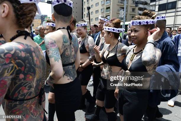 Heavily tattooed Japanese women walk in the street of Asakusa during &quot;Sanja Matsuri&quot; on May 18, 2019 in Tokyo, Japan. A boisterous...