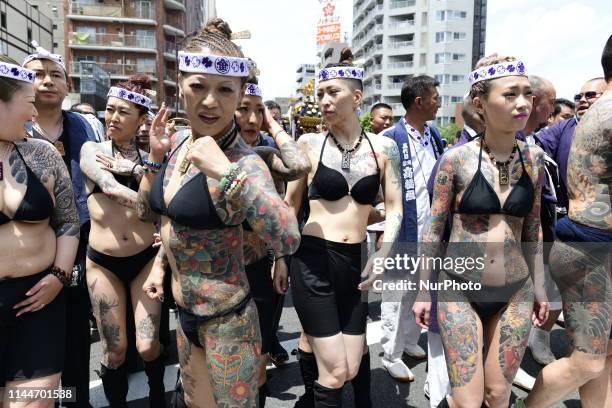 Heavily tattooed Japanese women walk in the street of Asakusa during &quot;Sanja Matsuri&quot; on May 18, 2019 in Tokyo, Japan. A boisterous...