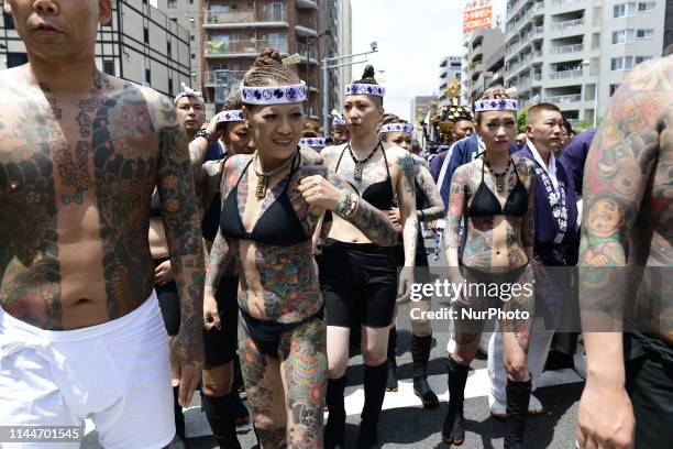 Heavily tattooed Japanese women walk in the street of Asakusa during &quot;Sanja Matsuri&quot; on May 18, 2019 in Tokyo, Japan. A boisterous...