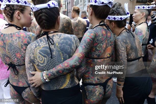 Heavily tattooed Japanese women chat as they wait for the portable shrine during &quot;Sanja Matsuri&quot; on May 18, 2019 in Tokyo, Japan. A...