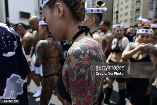 Heavily tattooed Japanese women walk in the street of Asakusa during &quot;Sanja Matsuri&quot; on May 18, 2019 in Tokyo, Japan. A boisterous...