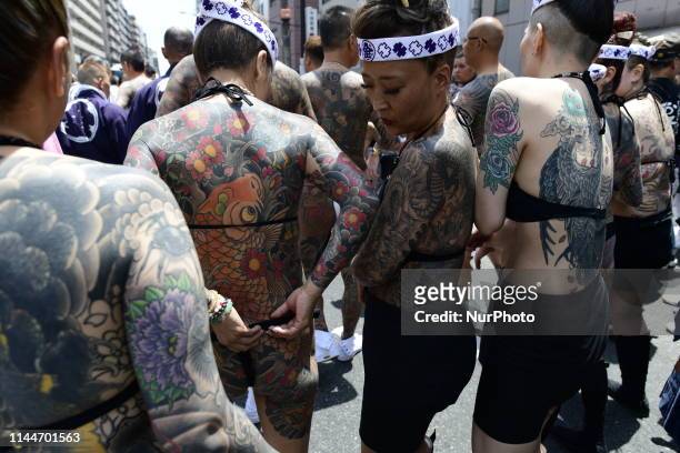 Heavily tattooed Japanese women chat as they wait for the portable shrine during &quot;Sanja Matsuri&quot; on May 18, 2019 in Tokyo, Japan. A...