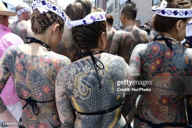 Heavily tattooed Japanese women chat as they wait for the portable shrine during &quot;Sanja Matsuri&quot; on May 18, 2019 in Tokyo, Japan. A...