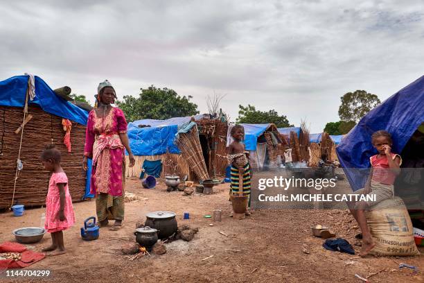 Fulani woman poses while she prepares a meal for her children in an Internally Displaced People's camp set up on the outskirts of Bamako on May 4,...