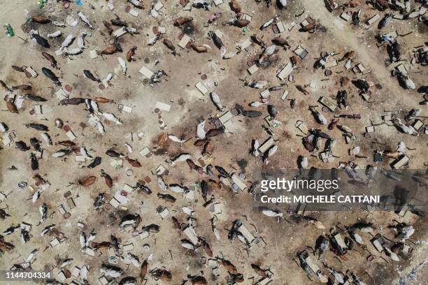 An aerial view shows a cattle market of Fulani herders next to an Internally Displaced People's camp set up on the outskirts of Bamako on May 9,...