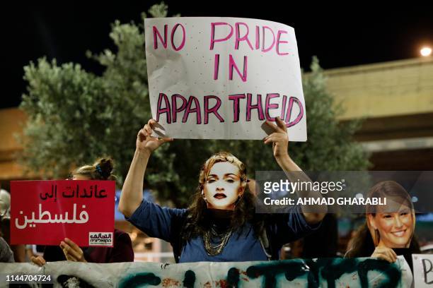 Demonstrator wearing a mask, bearing the likeness of American singer Madonna, during a protest calling for a boycott of the ongoing 2019 Eurovision...