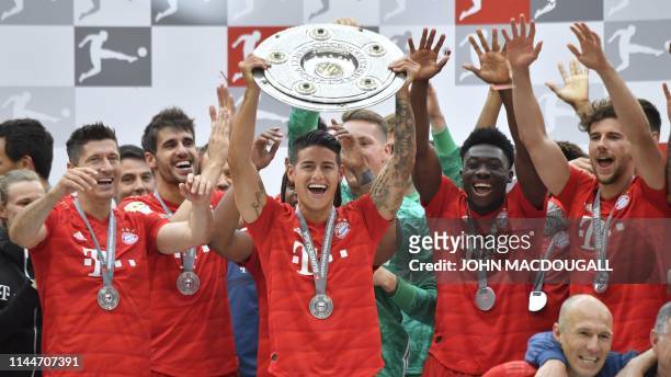 Bayern Munich's Polish forward Robert Lewandowski, Bayern Munich's Colombian midfielder James Rodriguez and Bayern Munich's Canadian midfielder...
