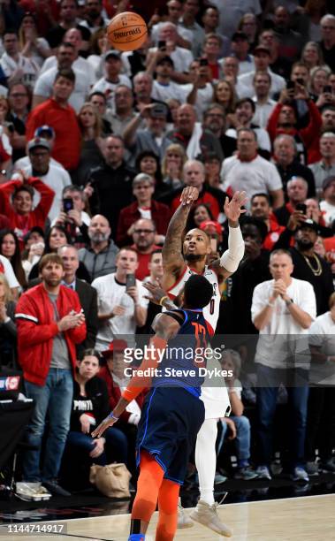 Damian Lillard of the Portland Trail Blazers hits the game winning shot over Paul George of the Oklahoma City Thunder in Game Five of the Western...