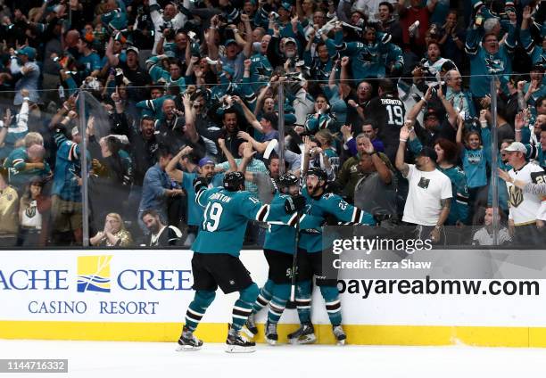 Barclay Goodrow of the San Jose Sharks is congratulated by Marc-Edouard Vlasic and Joe Thornton of the San Jose Sharks after he scored the game...