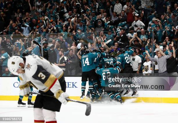 Barclay Goodrow of the San Jose Sharks is congratulated by teammates as Brayden McNabb of the Vegas Golden Knights skates off the ice after he scored...