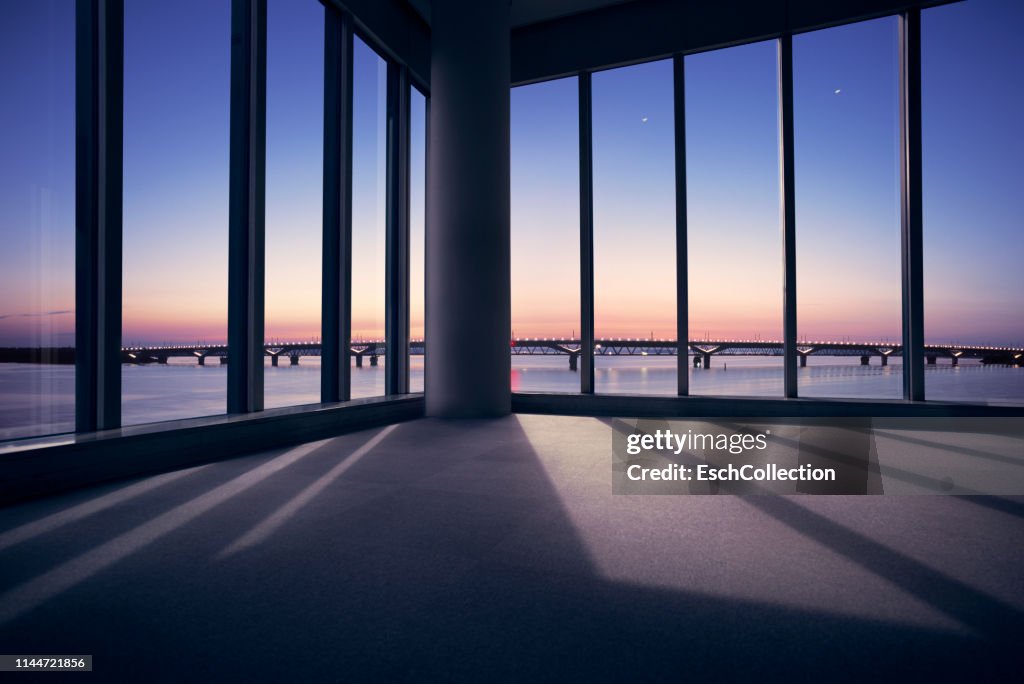 Modern office with window view of large bridge across river