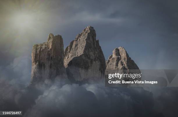 rocky mountains emerging from clouds - emerging from ground stock pictures, royalty-free photos & images