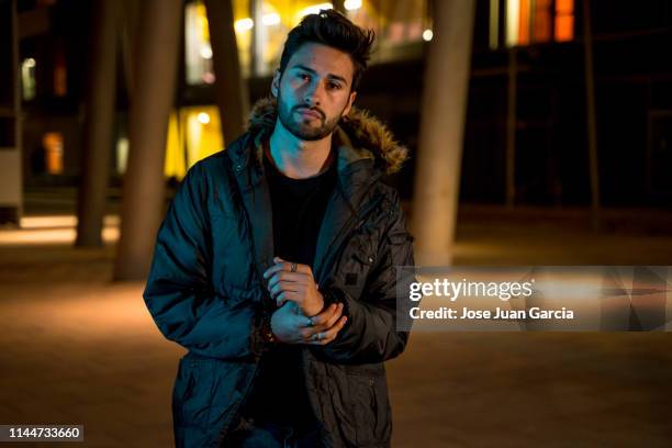 young man at the city at night - dark clothes stock pictures, royalty-free photos & images