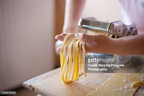 woman making some noodles - making stock-fotos und bilder