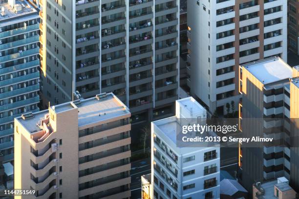 facades of residential buildings in tokyo - skyscraper roof stock pictures, royalty-free photos & images