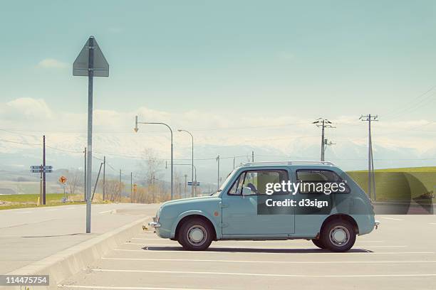 aqua color car in parking lot - 車　無人 ストックフォトと画像