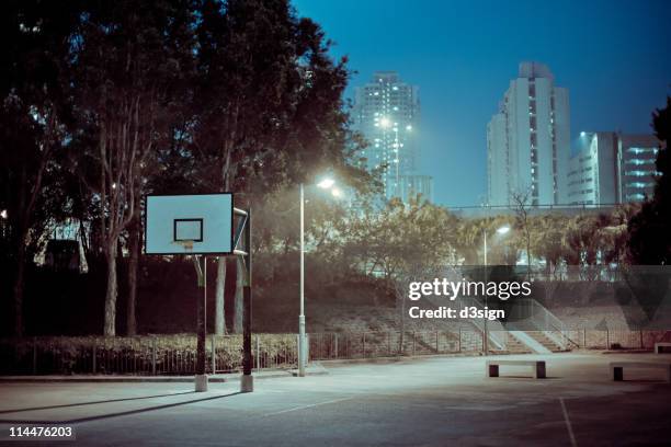 street basketball court at night - basketball on court stock-fotos und bilder