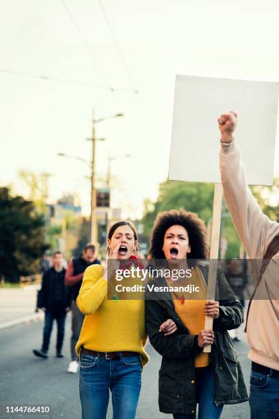 young protesters - marching stock pictures, royalty-free photos & images