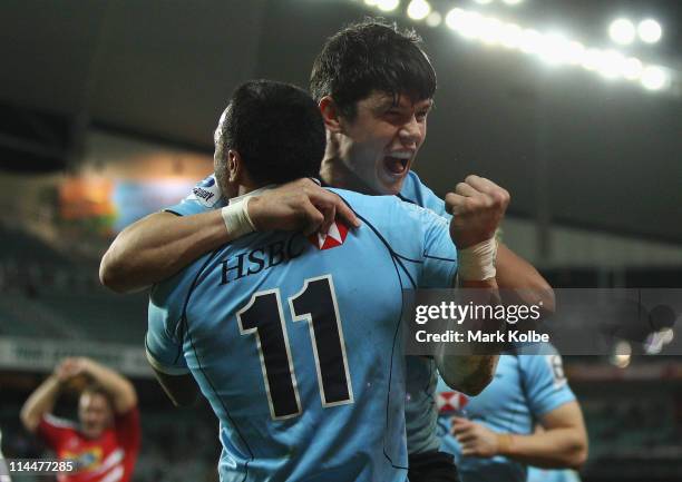 Tom Carter of the Waratahs congratulates Sosene Anesi of the Waratahs after he scored a try during the round 14 Super Rugby match between the...