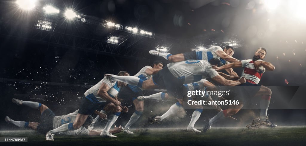 Men are playing rugby at stadium