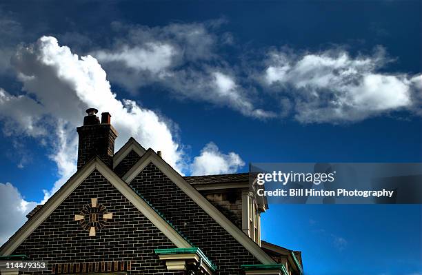 brick house roof and cloudy sky - cave junction stock pictures, royalty-free photos & images