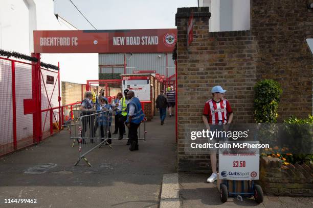 Programme seller outside the entrance to the New Road stand entrance pictured before Brentford hosted Leeds United in an EFL Championship match at...