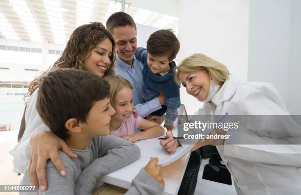 happy family at the dentistâs office - dental office stock pictures, royalty-free photos & images