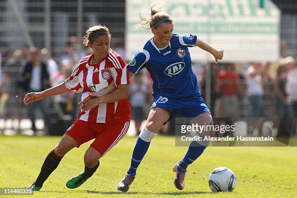 Laura Freisinger of Muenchen battles for the ball with Corina Schroeder of Postdam during the women Bundesliga Cup 2011 final match between FC Bayern...